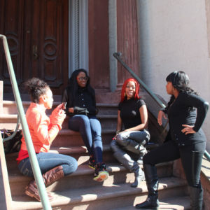 Group of women sitting on steps