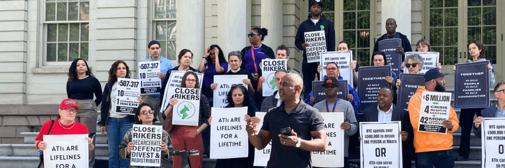 People holding posters in support of alternatives to incarceration.